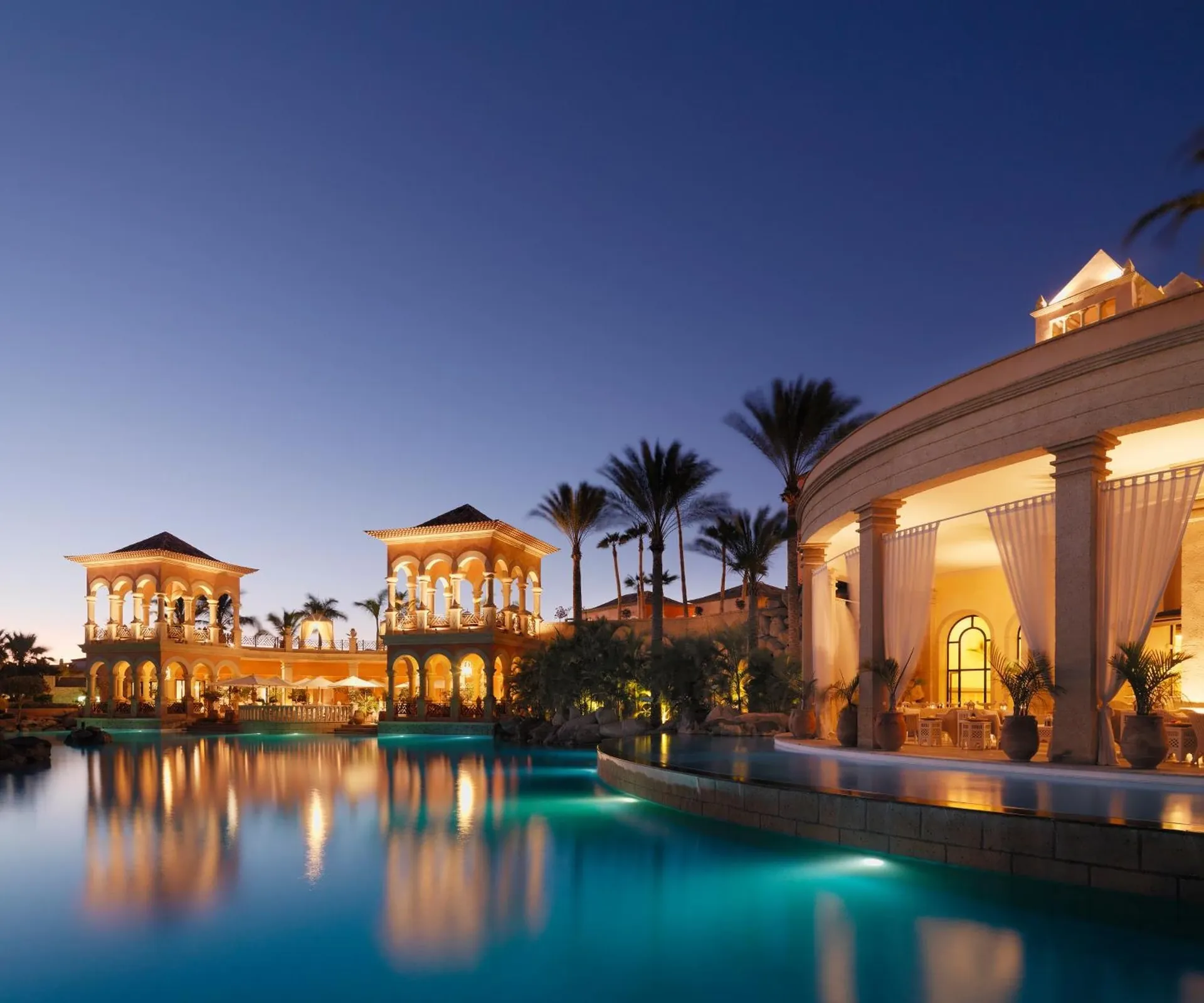 Arched pavilions and pool at dusk at JOIA El Mirador adults-only hotel, Costa Adeje, Tenerife