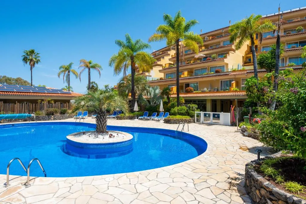 Hotel pool surrounded by palm trees in Puerto de la Cruz, Tenerife North
