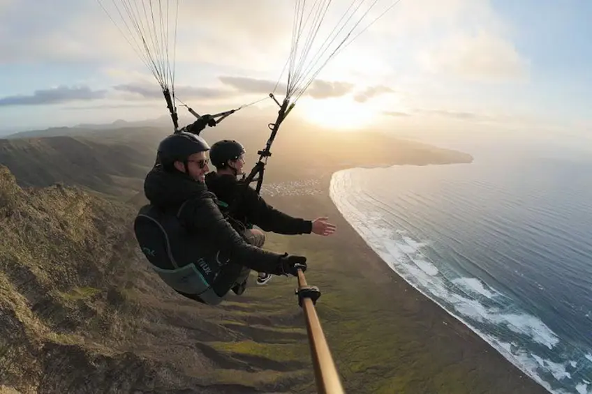 Tandem paragliding above the beach of Famara