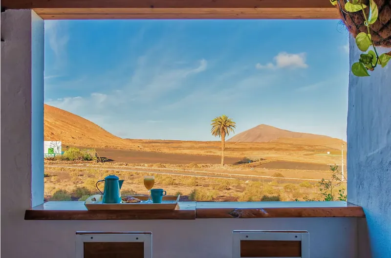 Window view over volcanic countryside at Finca Marisa, Tinajo
