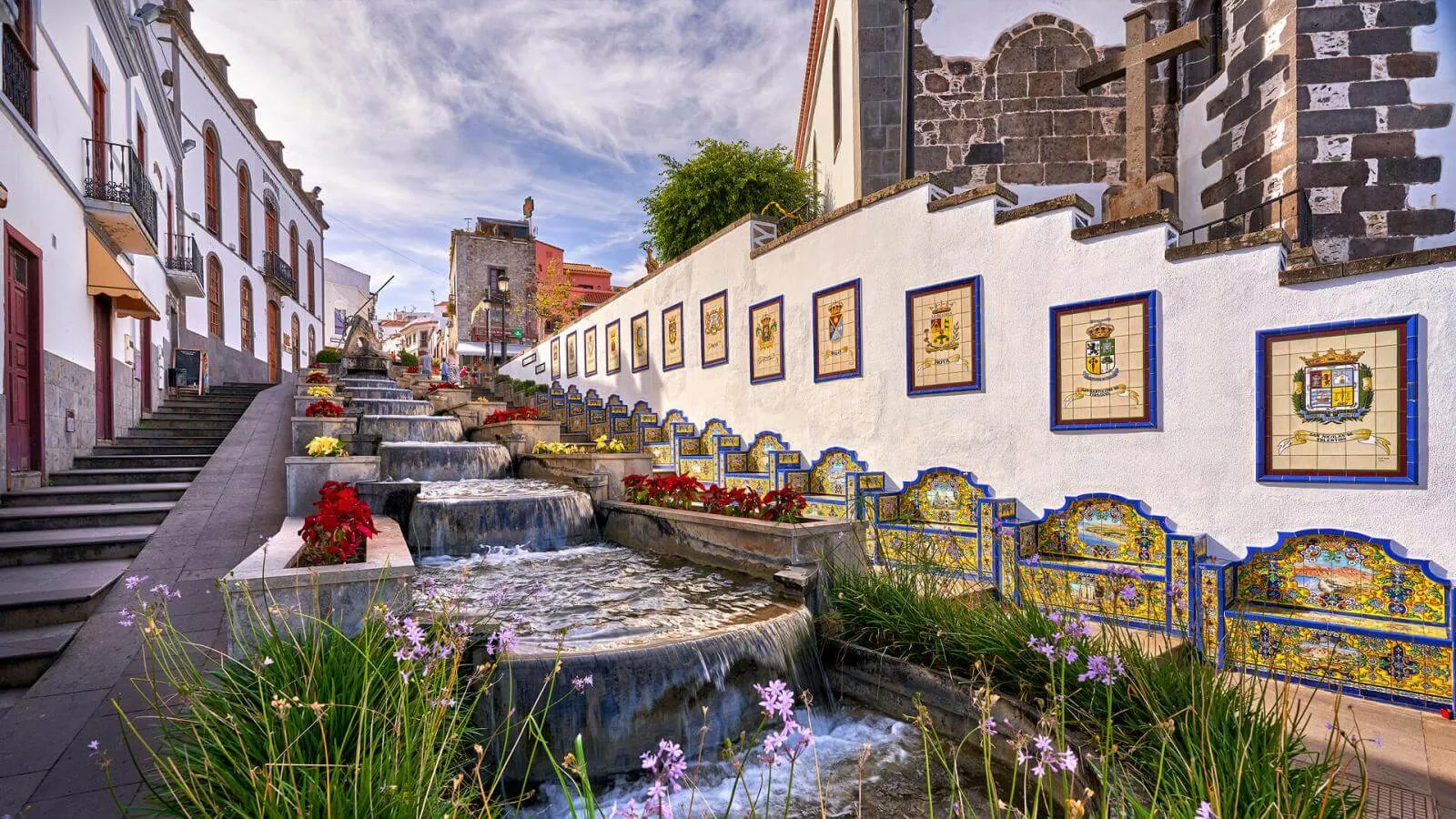 The tiled Paseo de Gran Canaria in Firgas, with a water cascade and ceramic benches