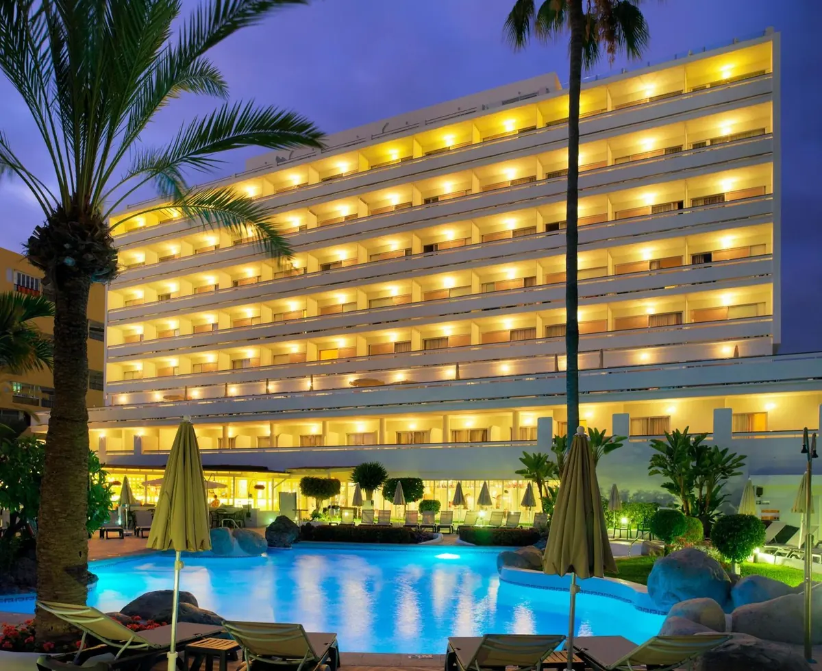 H10 Big Sur Boutique Hotel and pool lit up at dusk in Los Cristianos, Tenerife