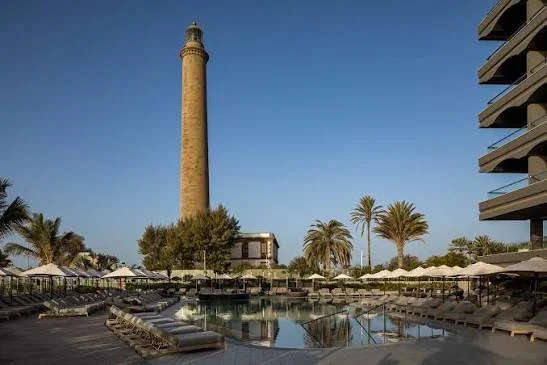 Pool deck and sun loungers beside the Maspalomas lighthouse at Hotel Faro, a Lopesan Collection Hotel in Meloneras, Gran Canaria