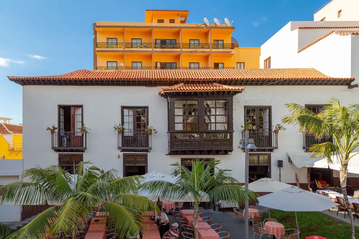 Historic facade with traditional wooden balcony and terrace at Hotel Marquesa, Puerto de la Cruz