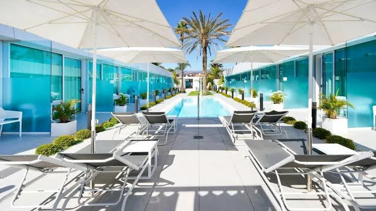 Poolside umbrellas and loungers at the intimate Hotel Nayra in Playa del Inglés, Gran Canaria