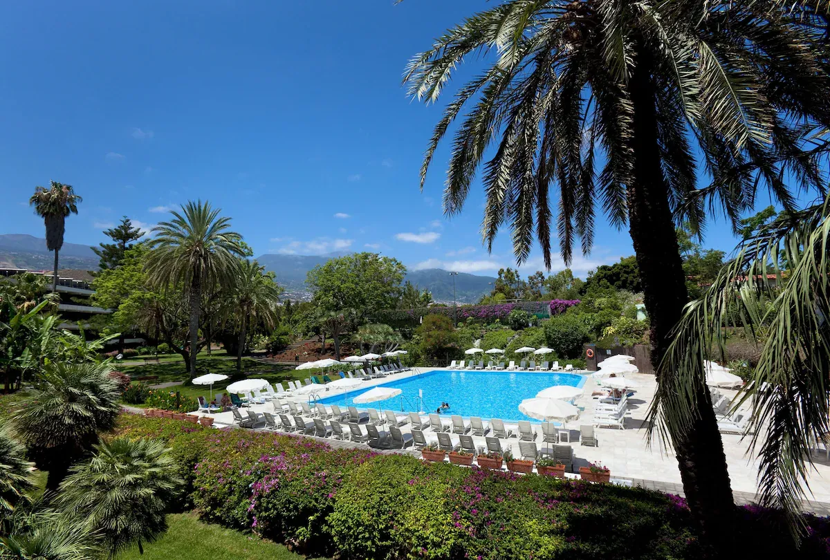 Pool and flowering gardens with mountain views at Hotel TRH Taoro Garden, Puerto de la Cruz