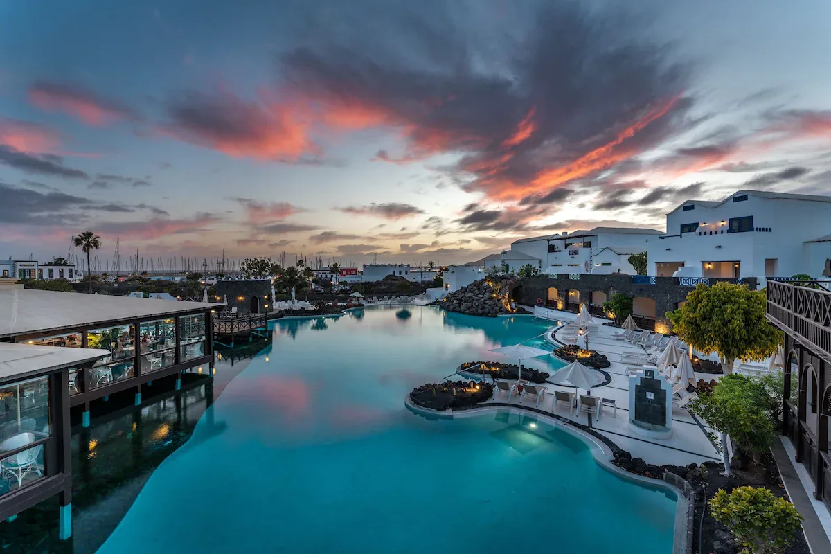 Lagoon pools of Hotel LIVVO Volcán Lanzarote at sunset, next to Marina Rubicón