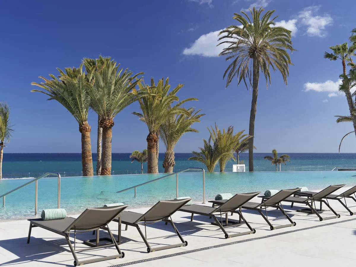 Infinity pool with palms and ocean views at Paradisus Gran Canaria, San Agustín