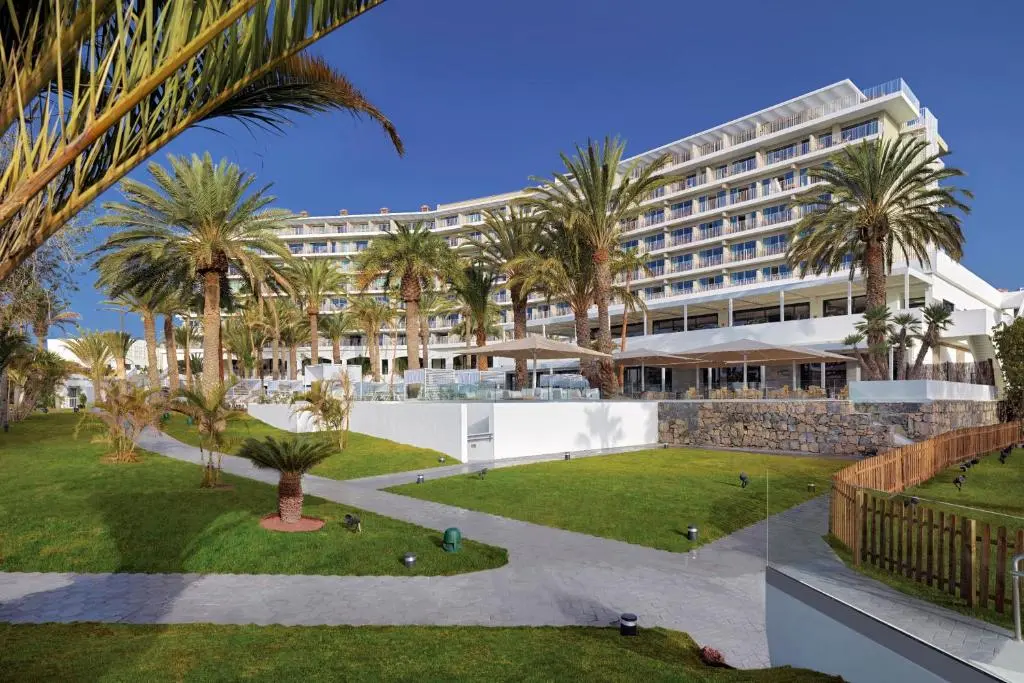 Beachfront pool and palm trees at Paradisus Gran Canaria, San Agustín