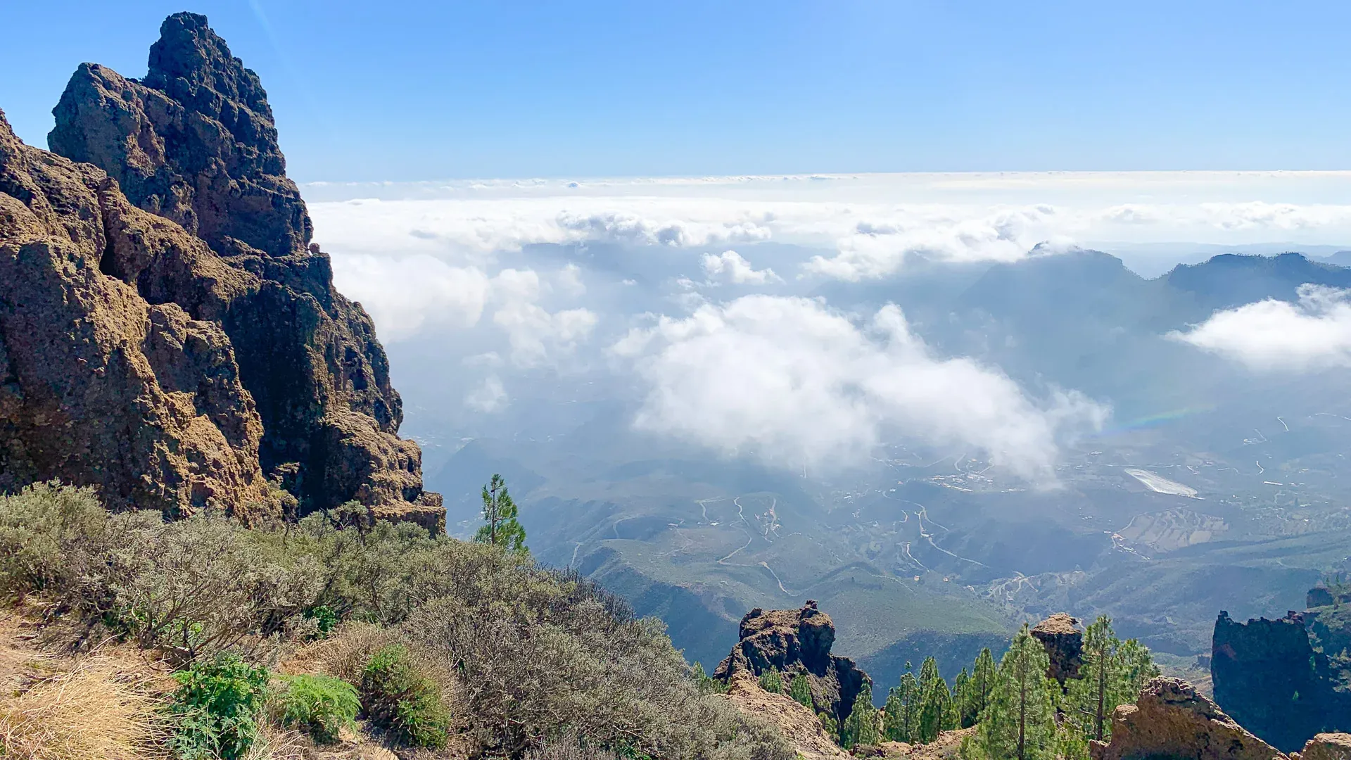 Volcanic crags near the summit of Pico de las Nieves above a sea of clouds