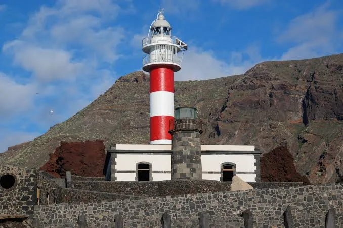 The red-and-white lighthouse at Punta de Teno beneath the cliffs of the Teno massif