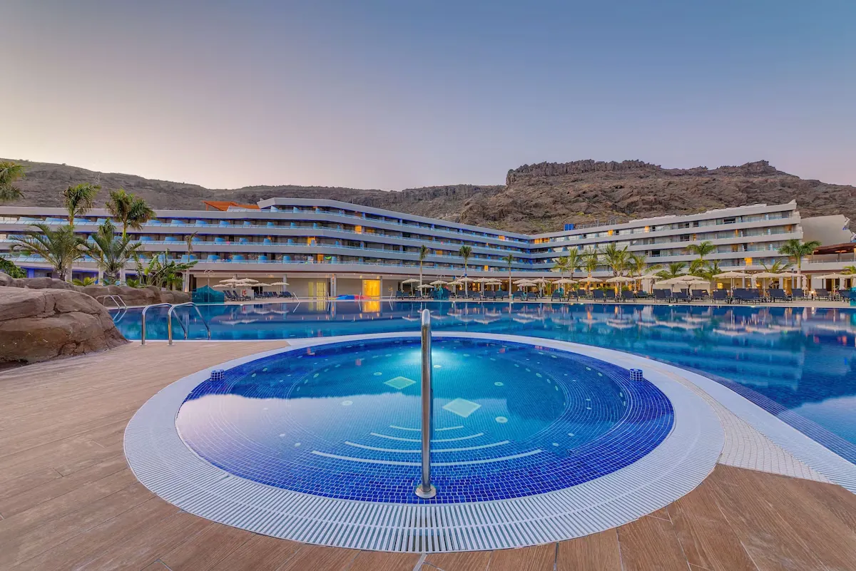 Pools and contemporary buildings at sunset at Radisson Blu Resort & Spa, Gran Canaria Mogán