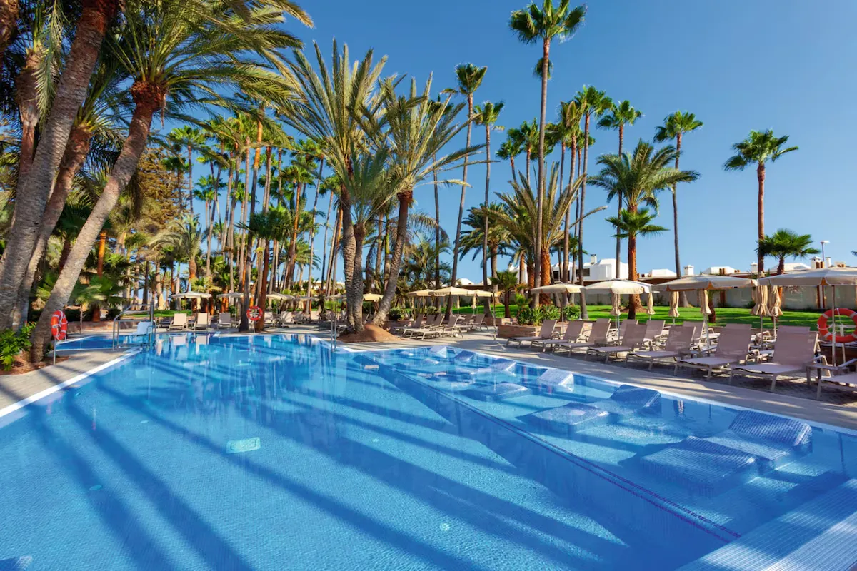 Pool and palms at Riu Palace Oasis