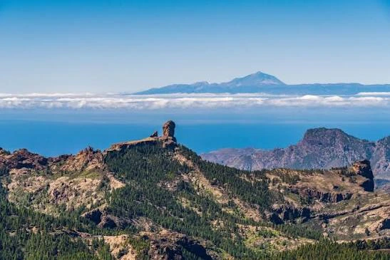 Hikers on the trail to Roque Nublo, Gran Canaria's iconic volcanic rock formation