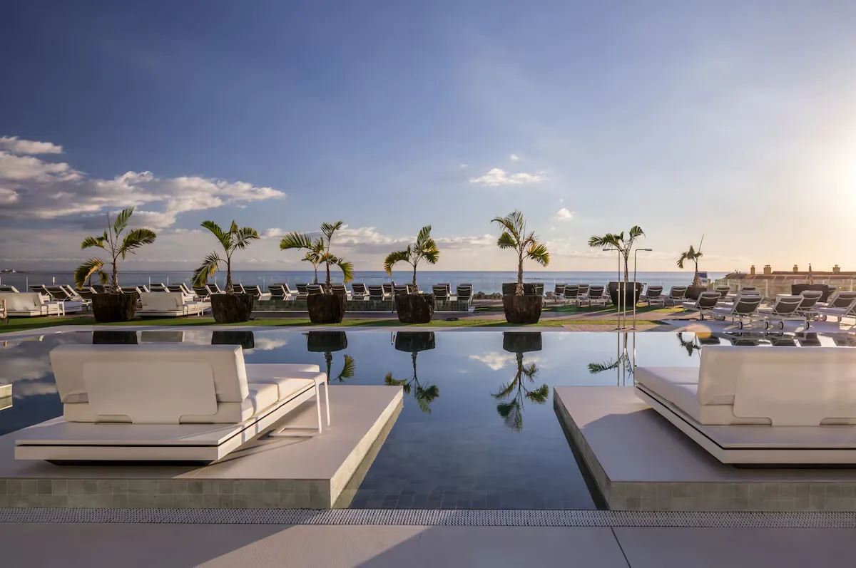 Pool deck with daybeds at sunset at Royal Hideaway Corales Suites, La Caleta