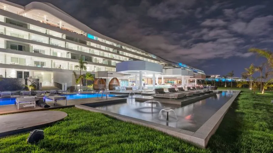 Illuminated modern facade and infinity-edge pool at night at Royal Hideaway Corales Beach in Costa Adeje, Tenerife