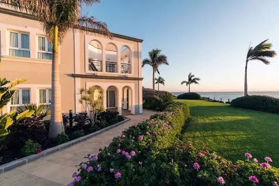Beachfront villa building with palm trees and gardens at Royal Palm Resort & Spa in Esquinzo, Fuerteventura