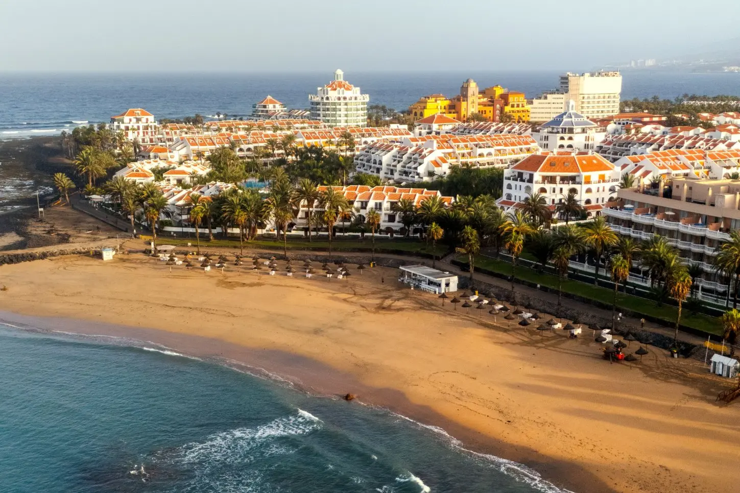 Aerial view of a golden beach and resort on the south coast of Tenerife