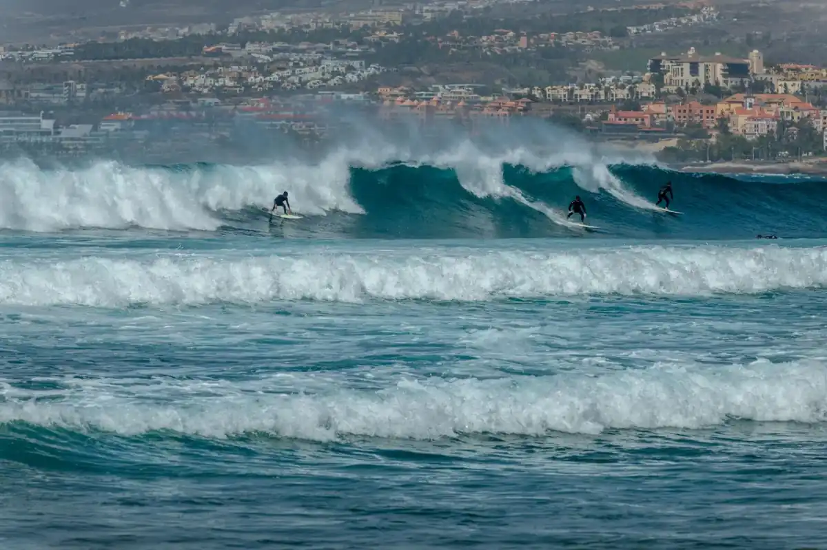 Surfers riding waves off the south coast of Tenerife