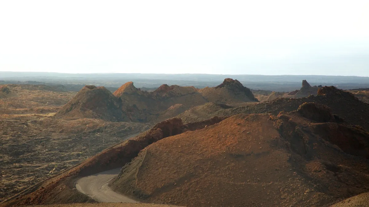 Volcanic cones and the winding Ruta de los Volcanes road in Timanfaya National Park